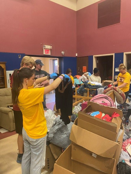 Students sorting clothes at the Child Care Partners.