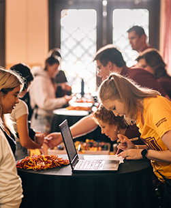 Students gathered in the entrance of the Hardin Administration Building are being assisted by the Admissions Office employees during an event.