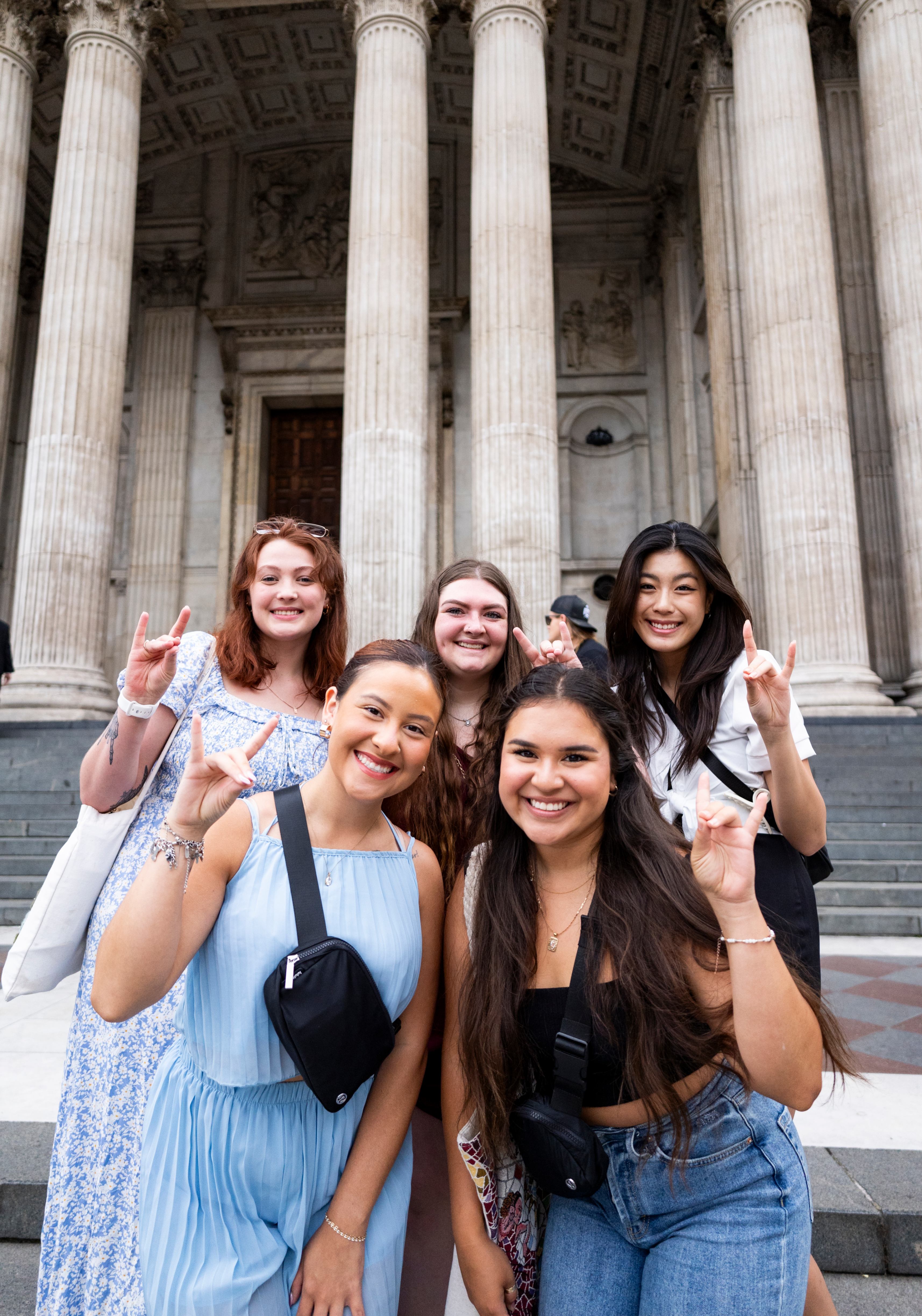 Girls pose outside of London museum
