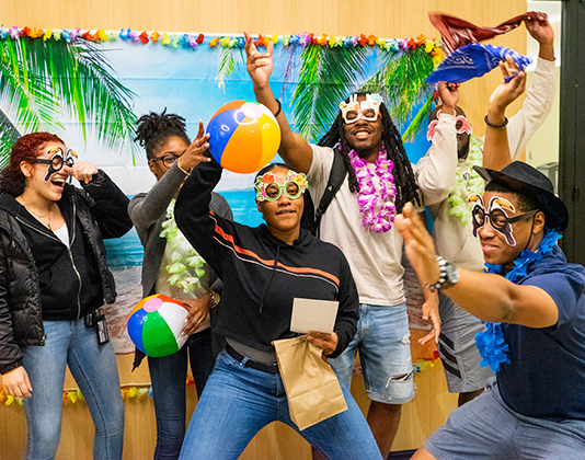 A playful group of students enjoy themselves during a tropical themed event.