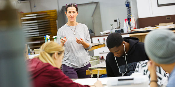 Art instructor in class giving a demonstration.